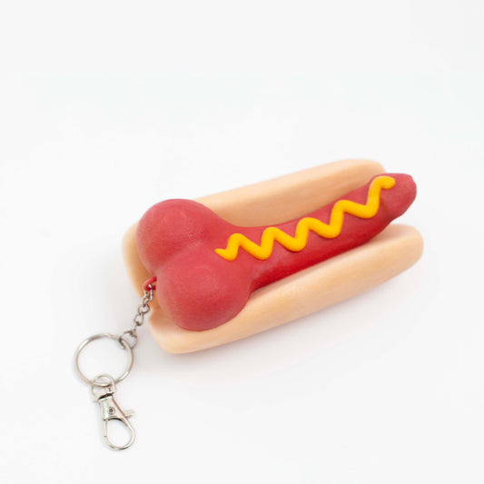 PENIS HOT DOG JUMBO CHARM on white, top view with the split key ring and dog-leash clip attached