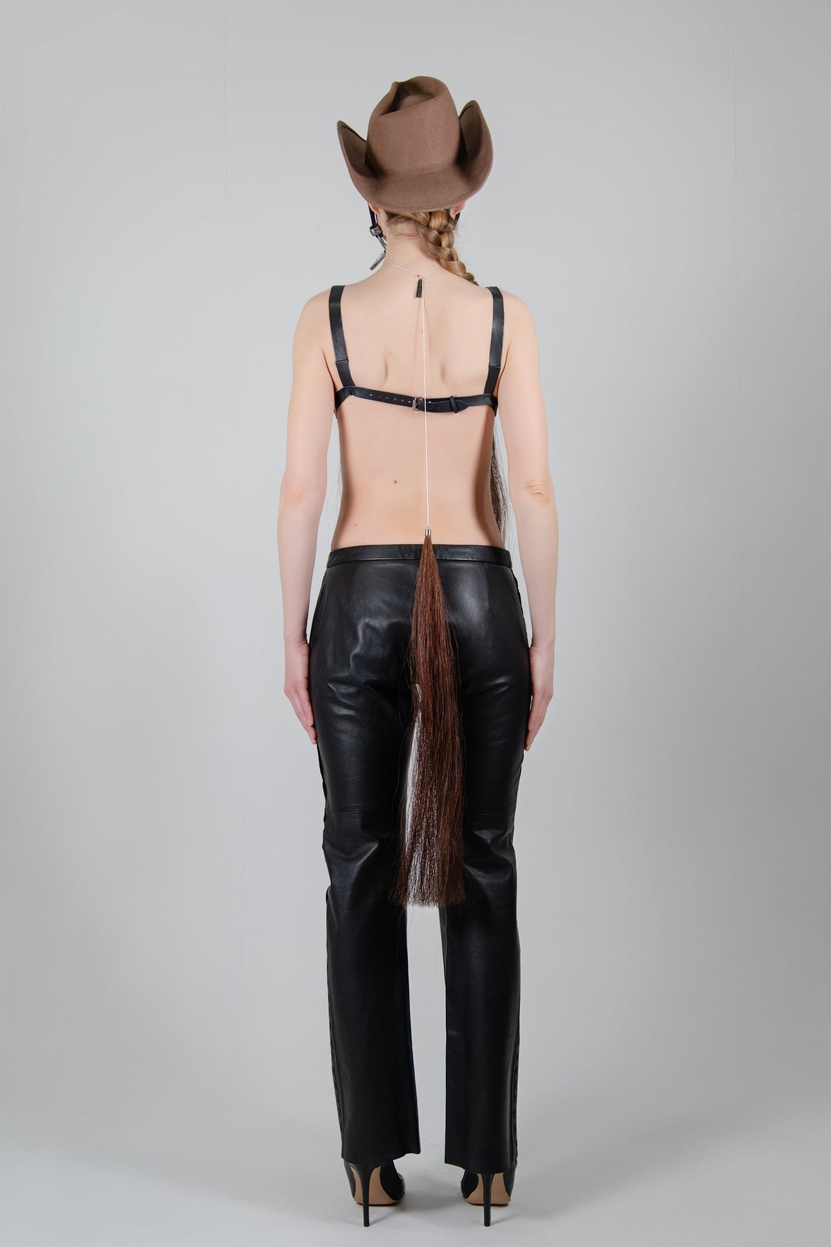 HORSE HAIR REVERSE NECKLACE (CHESTNUT), full-length back view with a brown cowboy hat, black trousers and heels