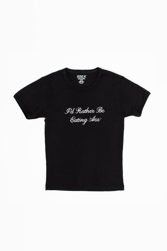 I'D RATHER BE EATING ASS CURSIVE BABY TEE front, laid flat: black baby tee with white cursive slogan and IRBEA neck label