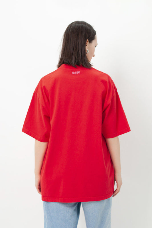 I'D RATHER BE EATING ASS OVERSIZED T-SHIRT back view on a model: plain red back with small pink IRBEA logo at the neck