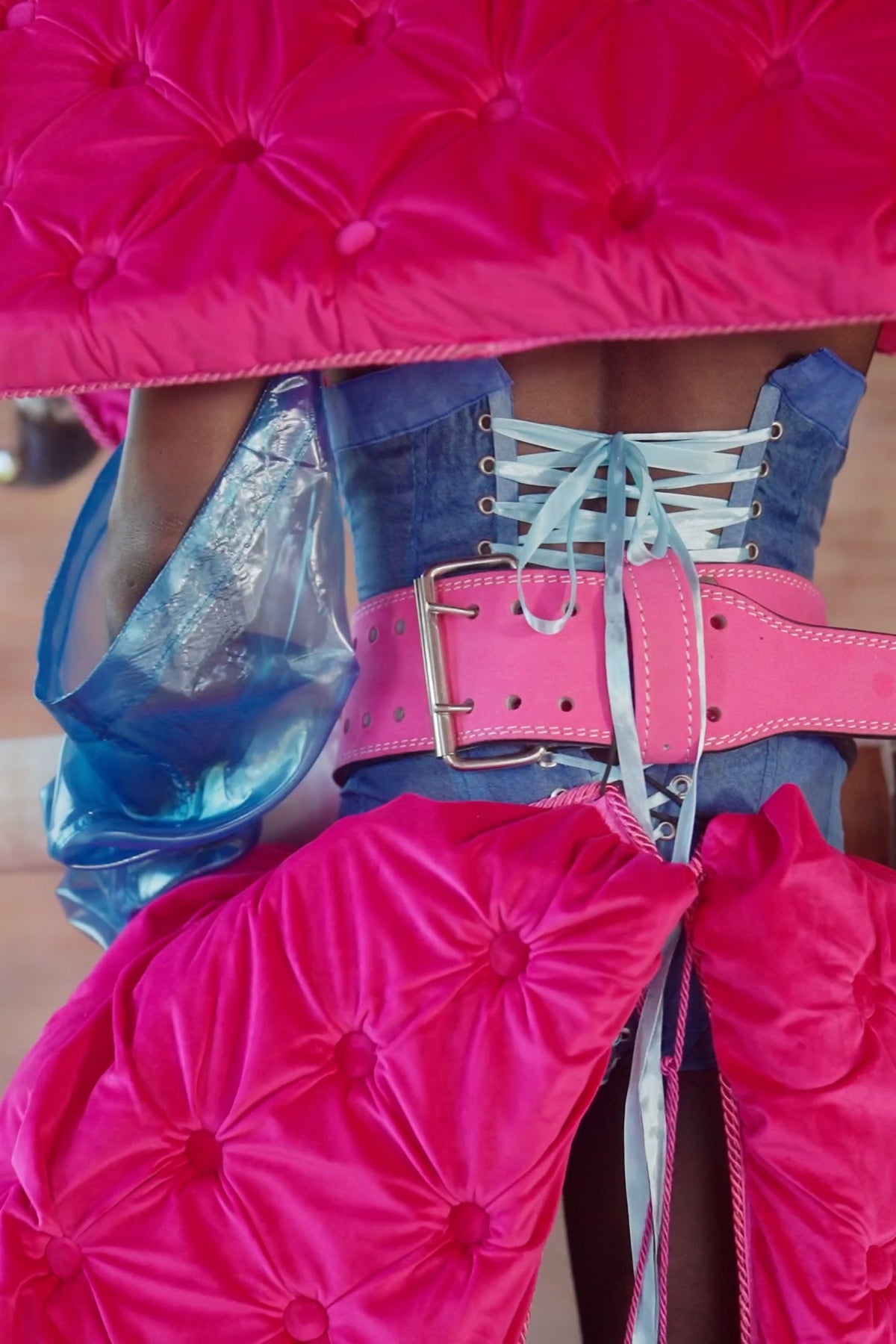 LOOK 5, Save A Horse, Ride A Cowboy: close-up of the corset's pale blue lacing and pink belt beneath the velvet