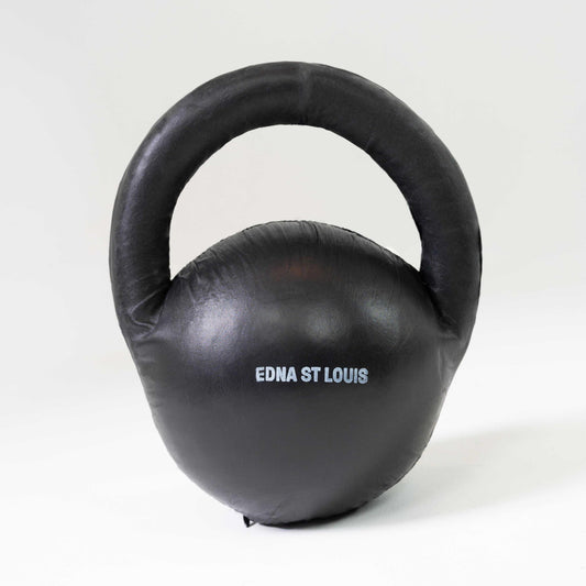 LIFT BAG on its own, back view: arched handle over a round body with "EDNA ST LOUIS" printed in white