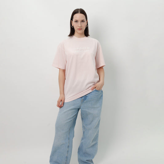 I'D RATHER BE EATING ASS OVERSIZED T-SHIRT - PINK full-length on a model, worn with wide light-wash jeans