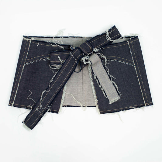 ASSLESS DENIM APRON SKIRT flat lay, back: open back with the ties knotted in a bow across the waistband