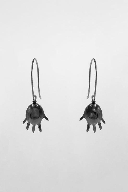 GLOVE BALLOON MINI EARRINGS, pair front view on grey: glossy black inflated gloves with fingers spread, on hook wires