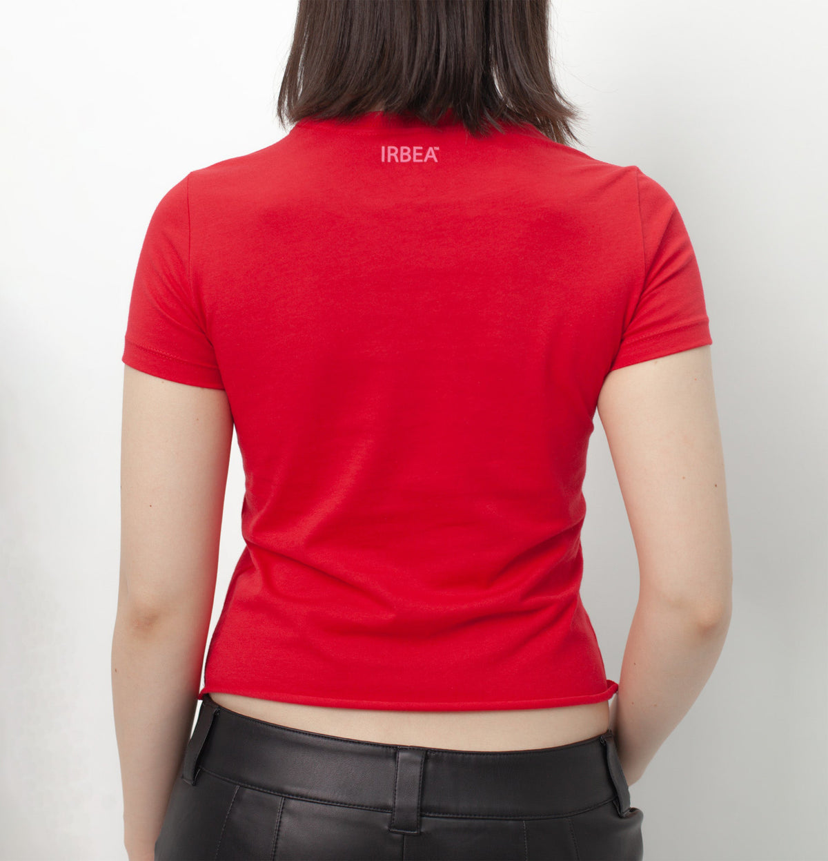 I'D RATHER BE EATING ASS T-SHIRT on a model, back view: plain red with a small pink "IRBEA" print below the collar