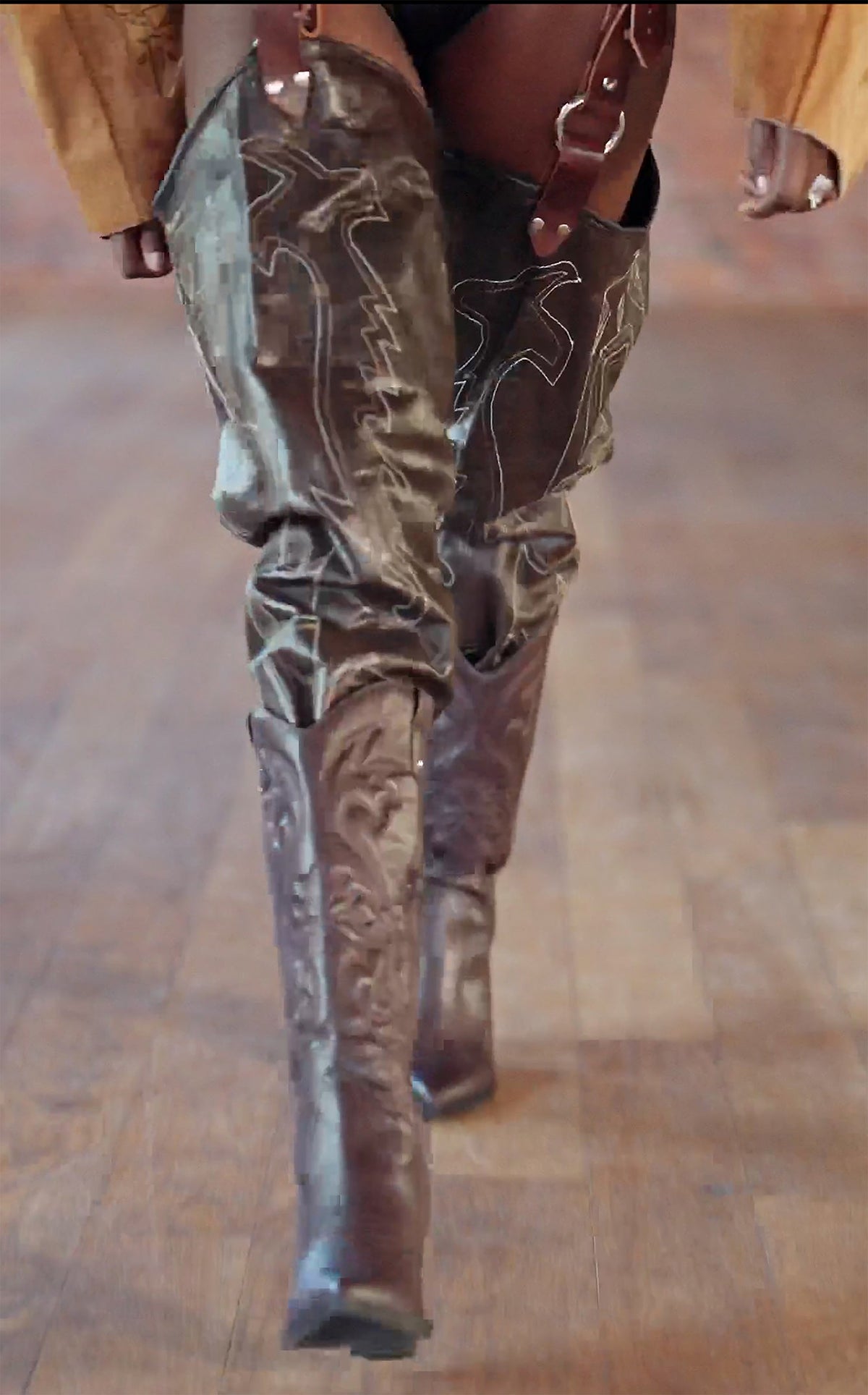 LOOK 3, Save A Horse, Ride A Cowboy: thigh-high cowboy boot chaps mid-stride, brown with pale western stitching