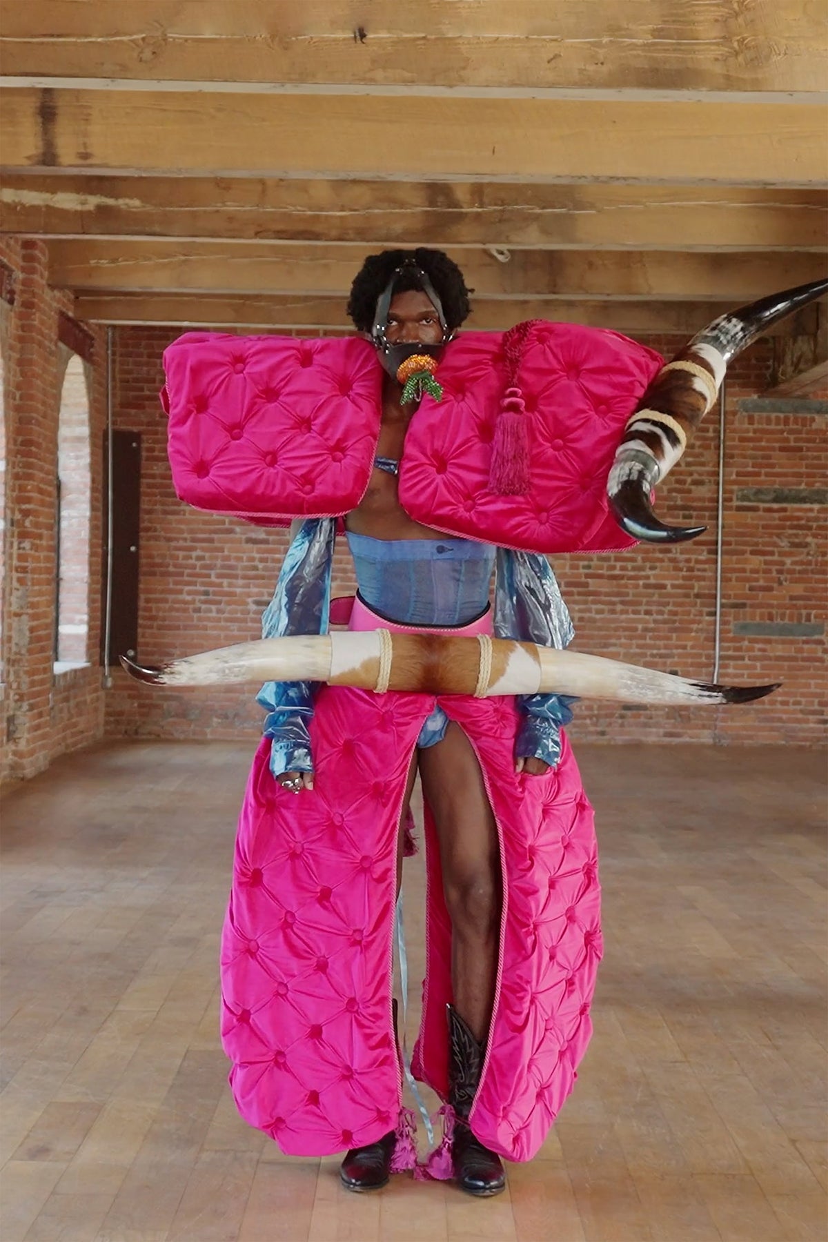 LOOK 5, Save A Horse, Ride A Cowboy: full front view, bull horn on one shoulder, pink tassel, cowboy boots under the velvet
