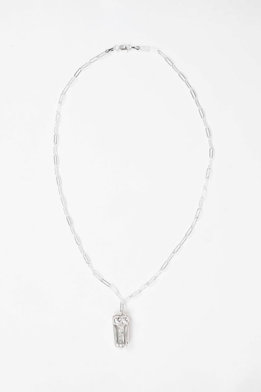 PENIS HOT DOG NECKLACE laid flat on white: full silver paperclip chain with clasp and the pendant