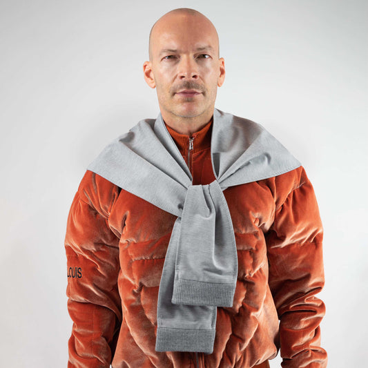 LIFT SHAWL, front view on a model: gray sweatpant "legs" permanently tied in a knot, rib-knit cuffs hanging down