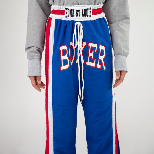 BOX TRACK PANT, close-up of the front: "EDNA ST LOUIS" elastic waistband, white drawstring and red-outlined "BOXER" letters