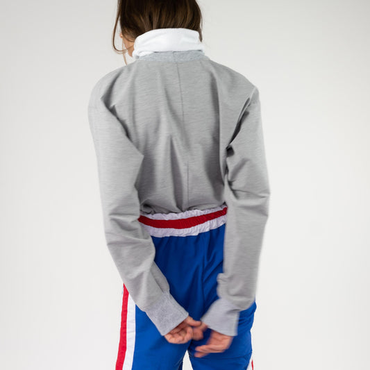 BOX SWEATSHIRT, back view on a model with hands clasped behind, showing the boxy fit and gray rib-knit cuffs