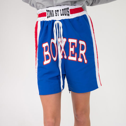 BOX TRACK PANT converted to boxing shorts, front view on a model: lower legs zipped off, "BOXER" across the front