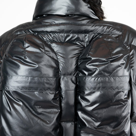 SCUBA PUFFER JACKET, close-up of the back: two rounded tank-shaped panels with strap-like seams in shiny black nylon