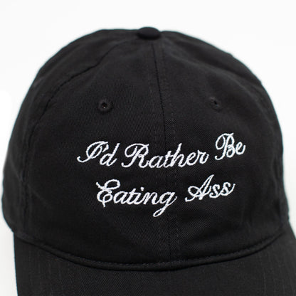 I'D RATHER BE EATING ASS CURSIVE BASEBALL CAP