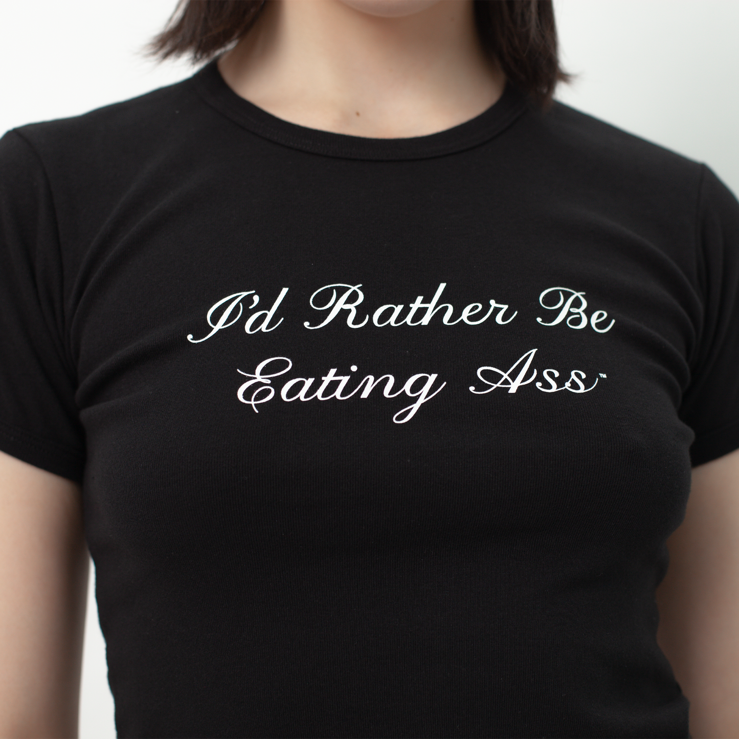 I'D RATHER BE EATING ASS CURSIVE BABY TEE